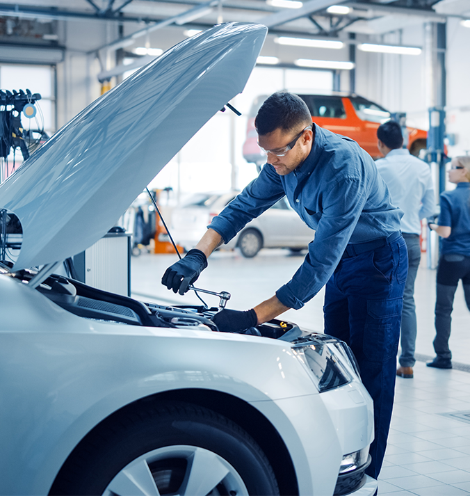 Mechanic working under car hood