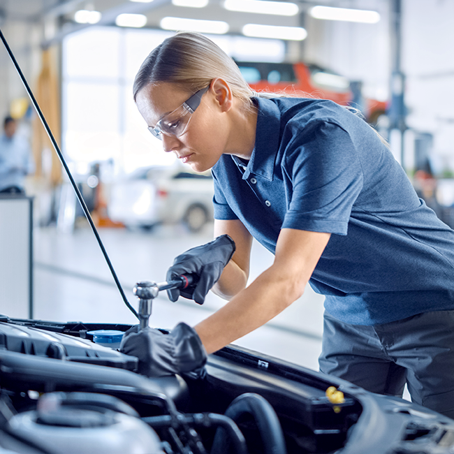 Mechanic working on car engine